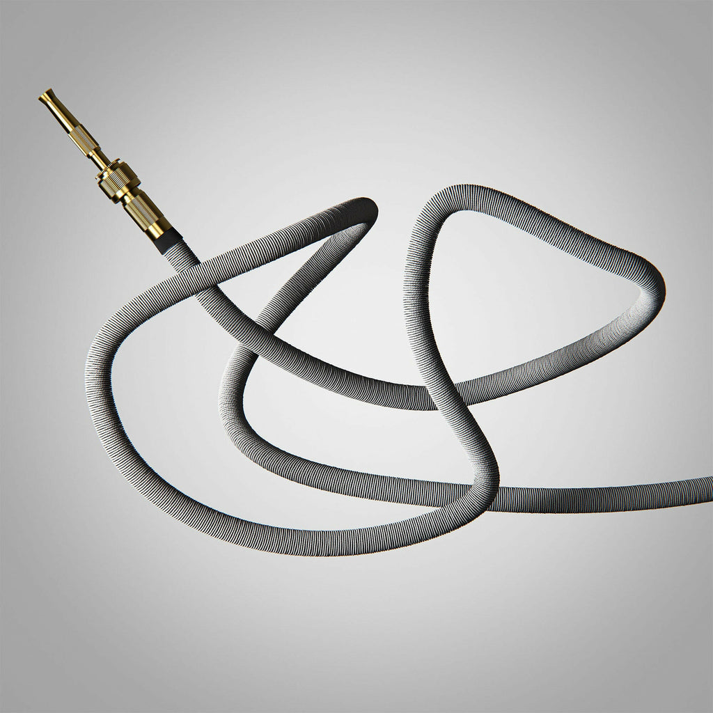 Fritz Tango Soft Expandable Garden Hose in grey, artistically coiled to emphasize its flexible and kink-free construction. Featuring durable brass fittings, ideal for modern garden care.